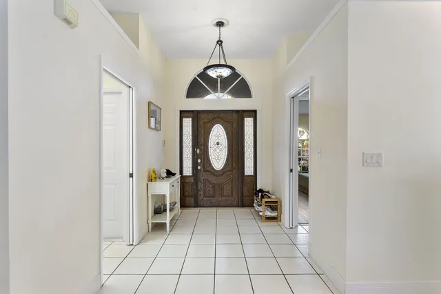a view of a room with wooden floor chandeliers and kitchen