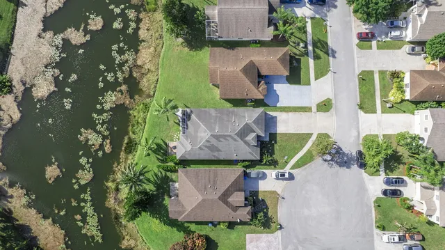 an aerial view of multiple houses with yard