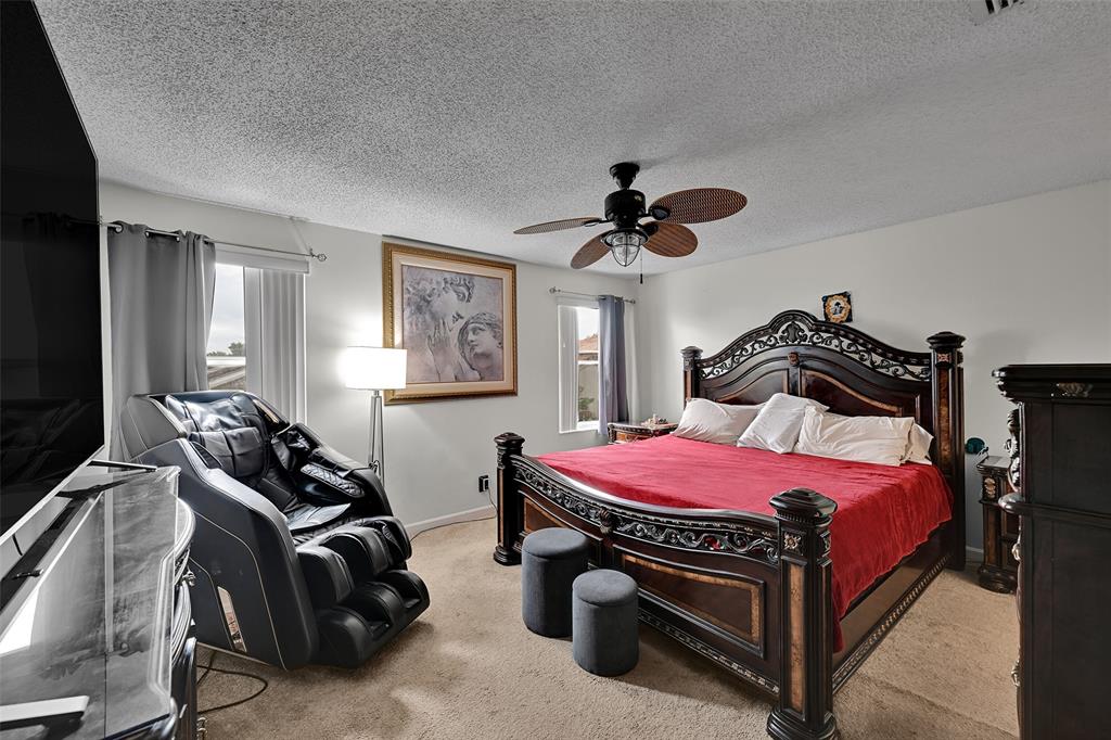 17332 Southwest 18th Street Miramar, FL 33029 - Photo 24 of 43 a bedroom with a bed and a tv on the dresser