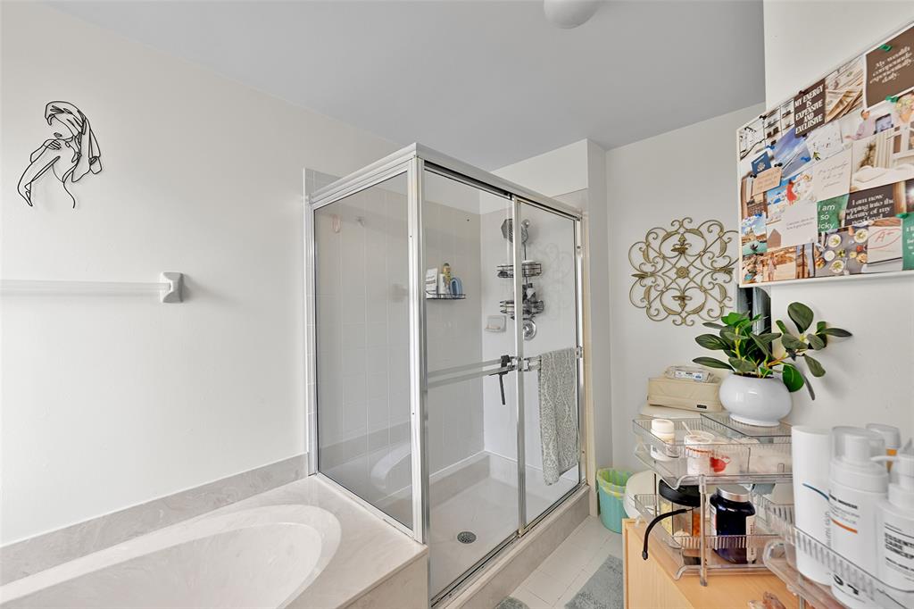 17332 Southwest 18th Street Miramar, FL 33029 - Photo 27 of 43 a bath room with a bathtub and shower