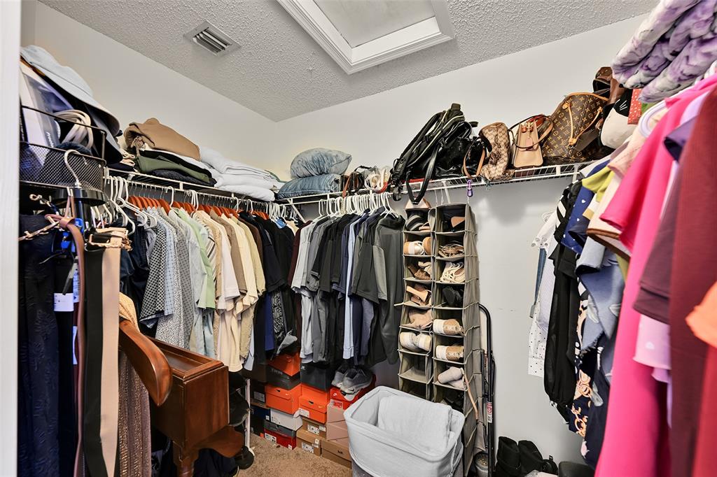 17332 Southwest 18th Street Miramar, FL 33029 - Photo 28 of 43 a view of walk in closet with clothes and shoes