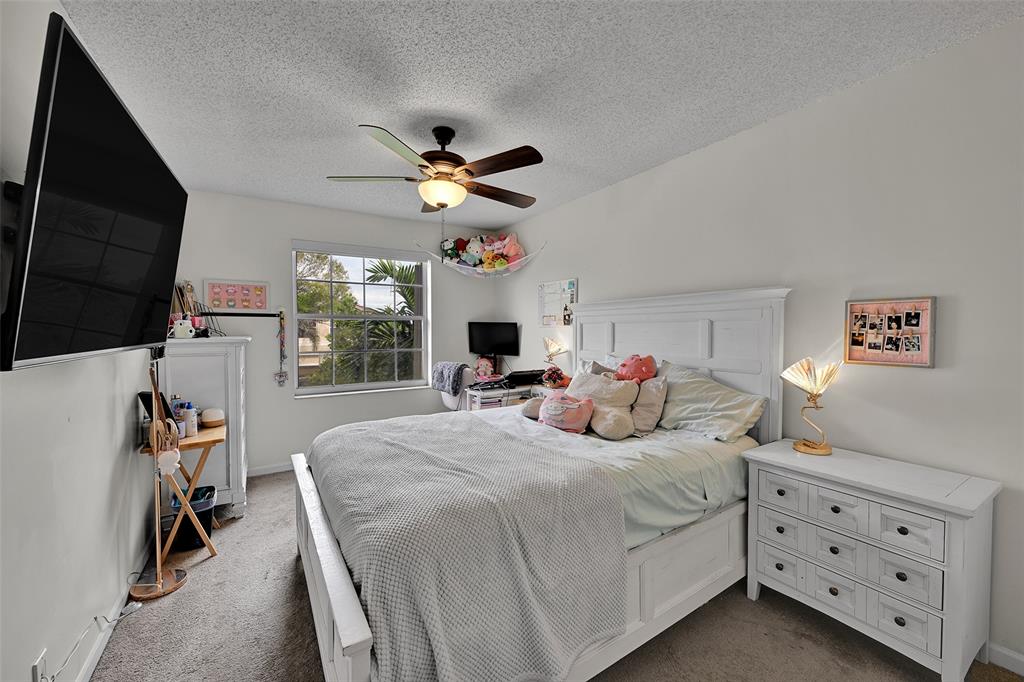 17332 Southwest 18th Street Miramar, FL 33029 - Photo 30 of 43 a bedroom with a bed a window and a flat screen television