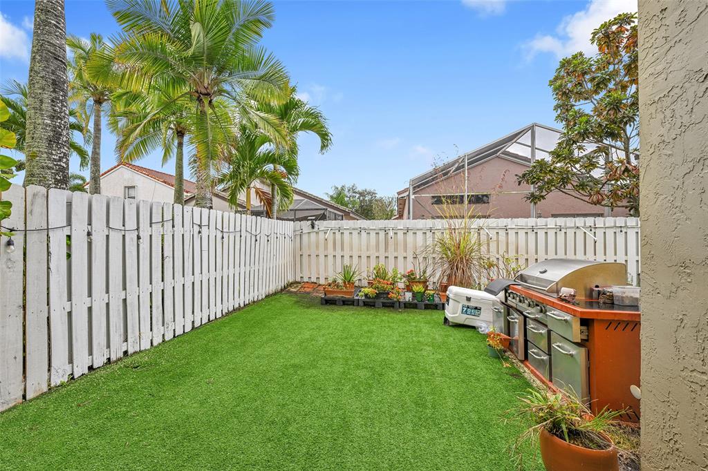 17332 Southwest 18th Street Miramar, FL 33029 - Photo 34 of 43 a view of a deck with a trees and wooden fence