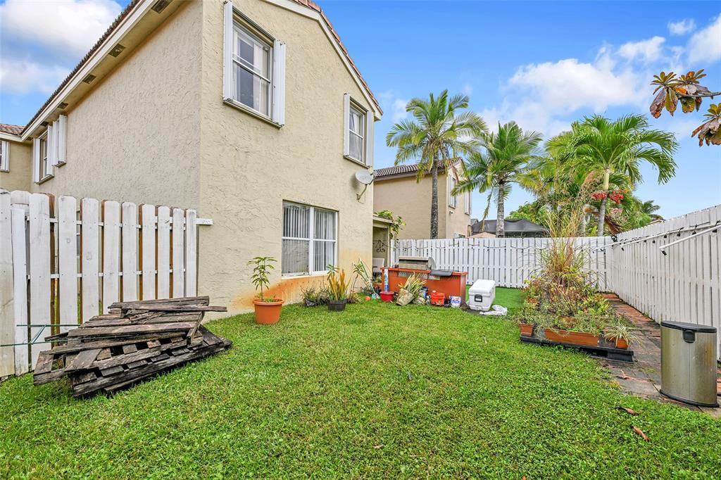 17332 Southwest 18th Street Miramar, FL 33029 - Photo 36 of 43 a backyard of a house with table and chairs