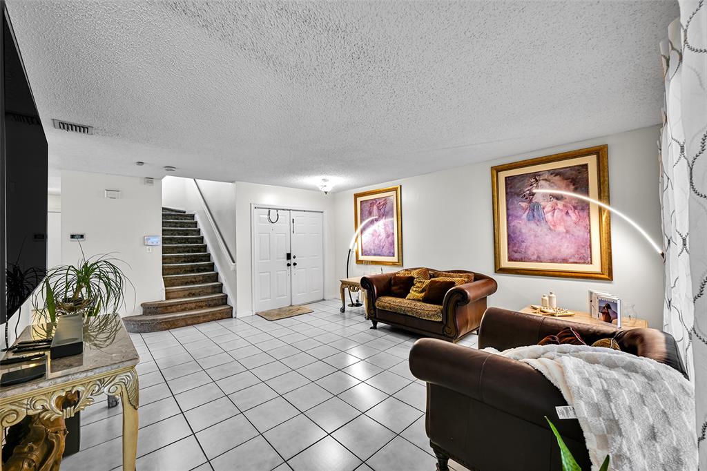 17332 Southwest 18th Street Miramar, FL 33029 - Photo 6 of 43 a living room with furniture and stairs