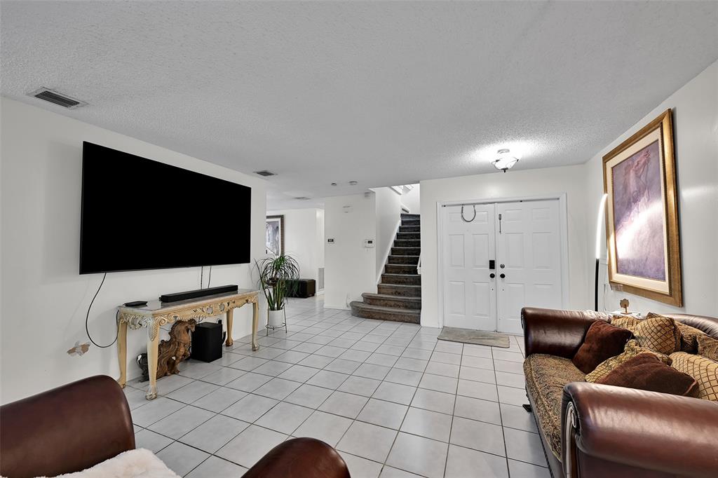 17332 Southwest 18th Street Miramar, FL 33029 - Photo 7 of 43 a living room with furniture and a flat screen tv