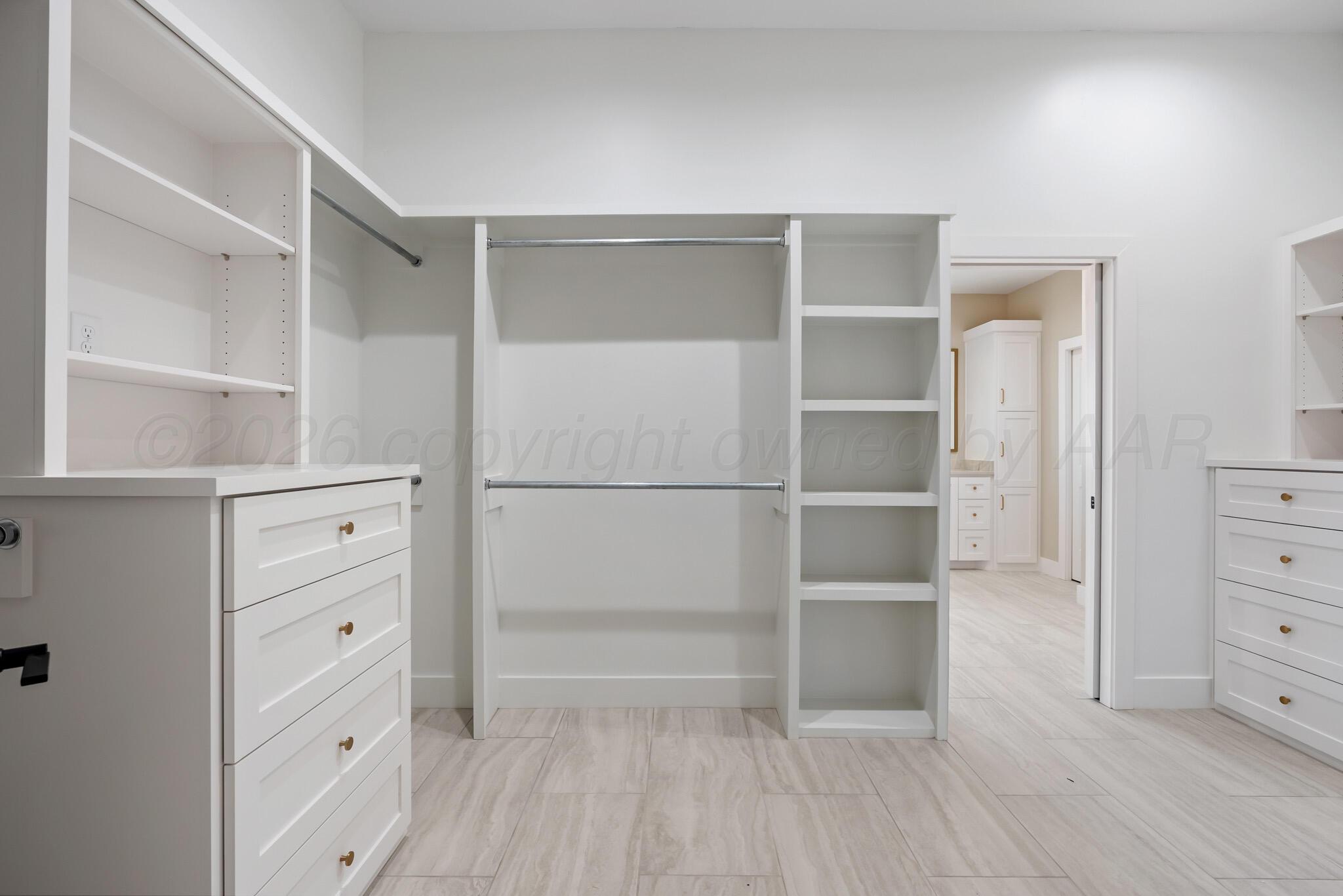 4201 Juniper Springs Road Amarillo, TX 79119 - Photo 20 of 27 a room with white cabinets and wooden floor