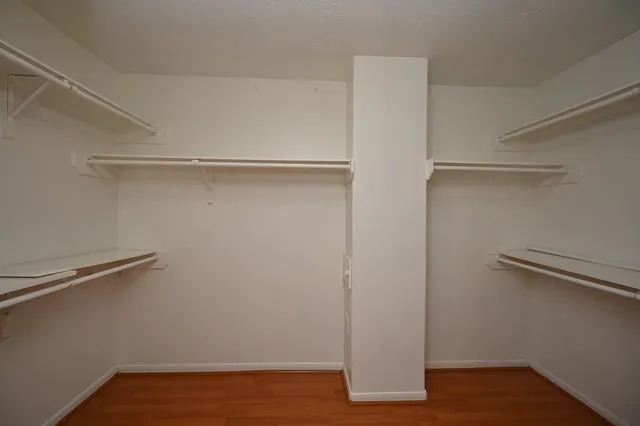 a view of an empty room and wooden floor