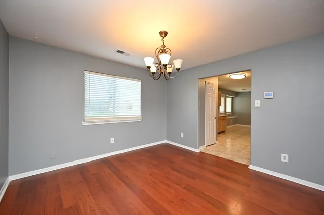 a view of wooden floor and windows in a room
