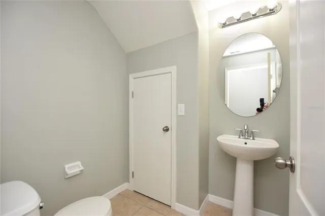 a bathroom with a sink mirror and toilet