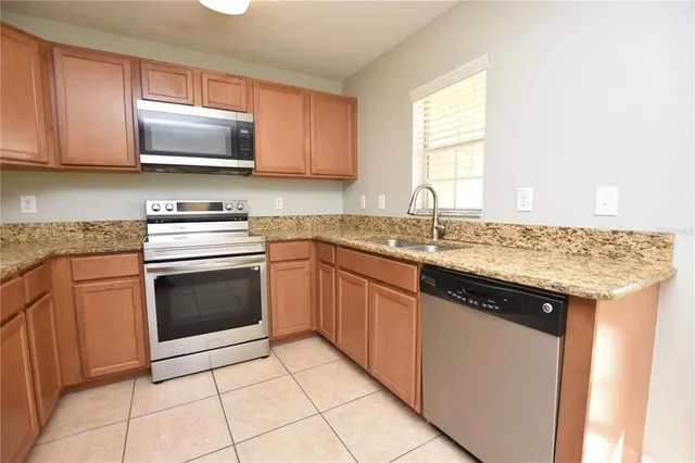 a kitchen with a sink stove and microwave