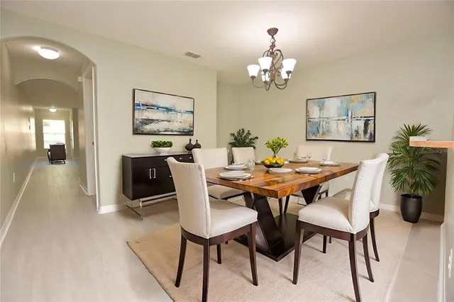 a dining room with furniture and chandelier