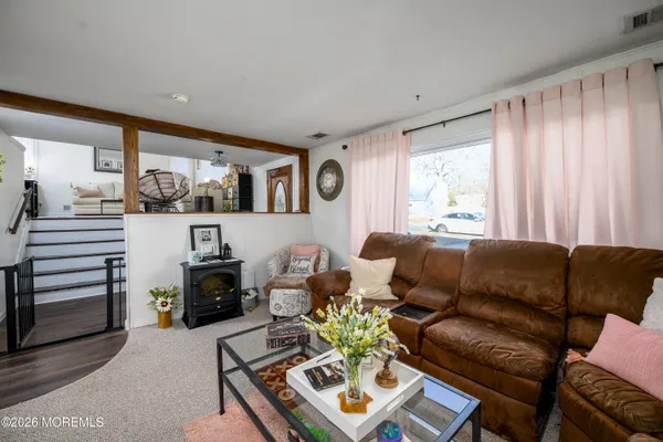 a living room with furniture a clock and a window