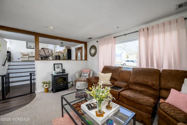 a living room with furniture a clock and a window