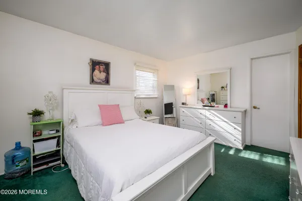 a bedroom with a bed and a flat tv screen