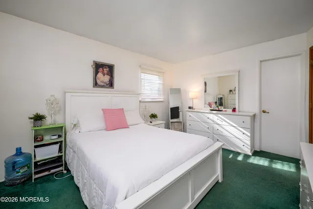 a bedroom with a bed and a flat tv screen