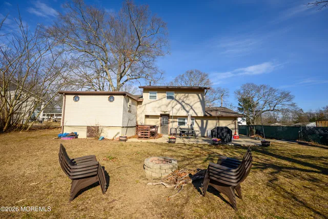 a view of a backyard with table and chairs under an umbrella