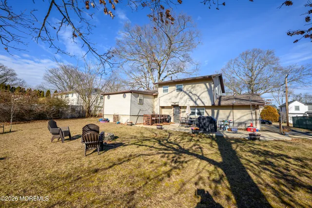 a view of a backyard with table and chairs under an umbrella