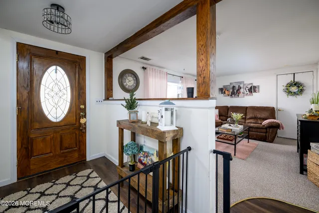 a view of a livingroom with furniture hardwood floor and a view of living room