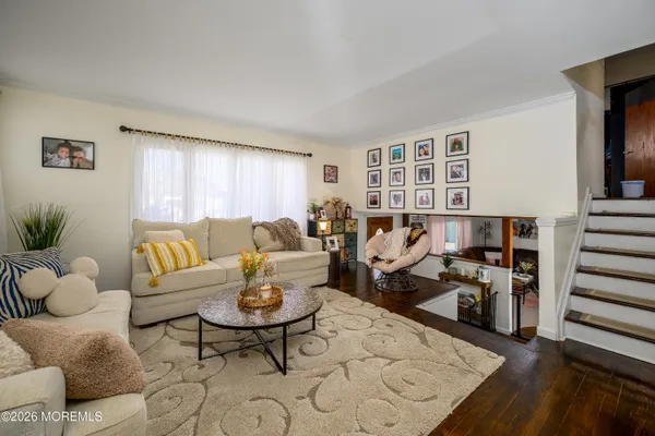 a living room with furniture and wooden floor