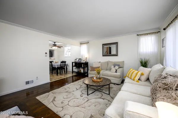 a living room with furniture and wooden floor