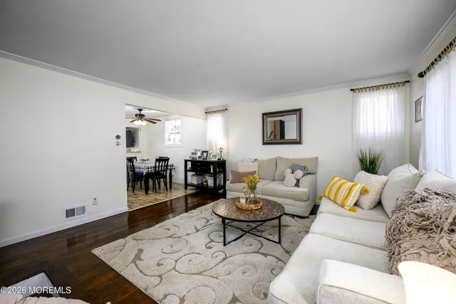 a living room with furniture and wooden floor
