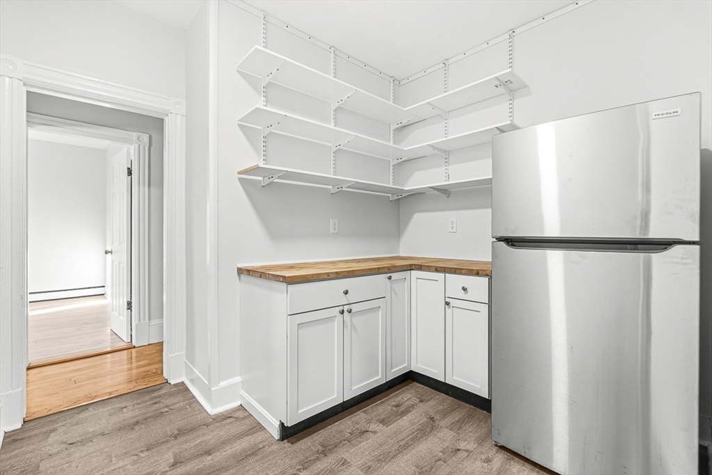 22 Royal Street Boston, MA 02134 - Photo 14 of 42 a kitchen with cabinets and a refrigerator