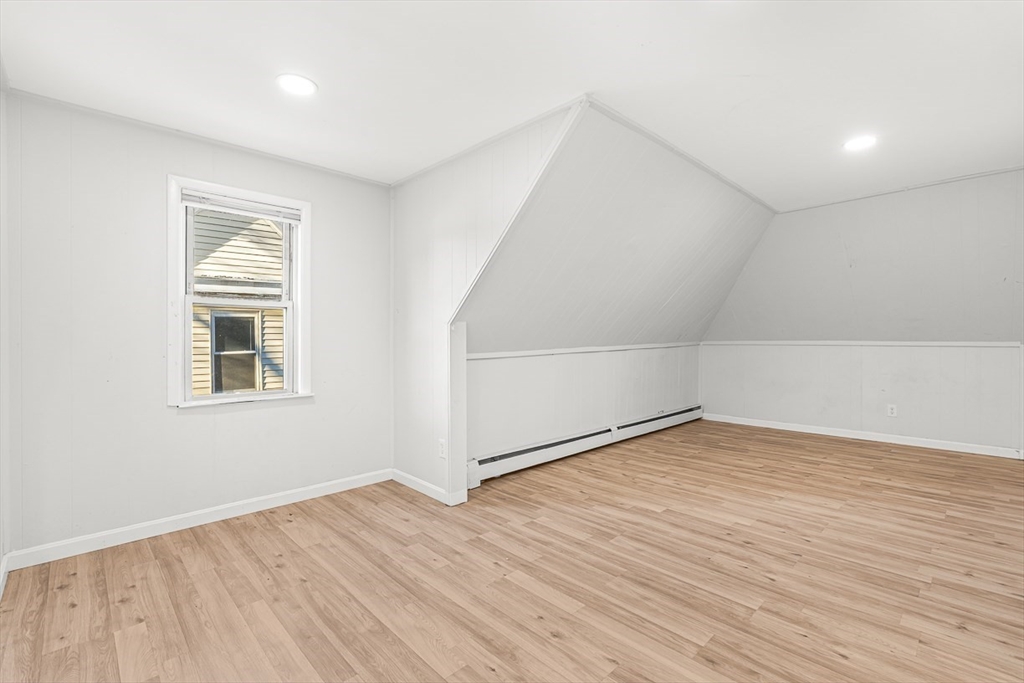 22 Royal Street Boston, MA 02134 - Photo 16 of 42 an empty room with wooden floor and windows
