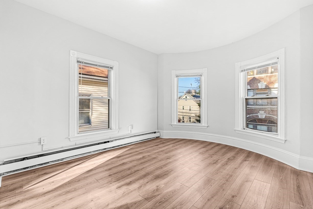 22 Royal Street Boston, MA 02134 - Photo 19 of 42 an empty room with wooden floor and windows
