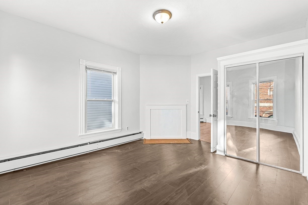 22 Royal Street Boston, MA 02134 - Photo 21 of 42 an empty room with wooden floor and windows