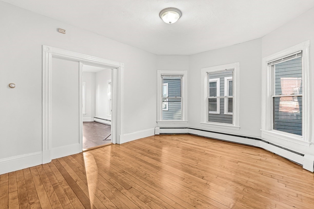 22 Royal Street Boston, MA 02134 - Photo 24 of 42 an empty room with wooden floor and windows