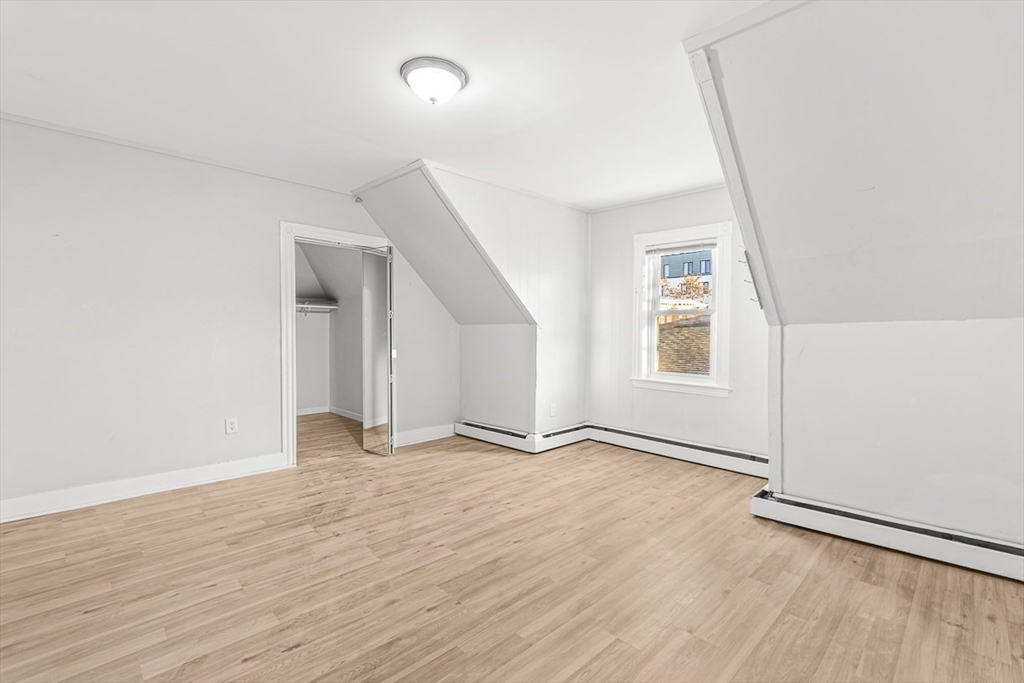 22 Royal Street Boston, MA 02134 - Photo 30 of 42 an empty room with wooden floor and windows