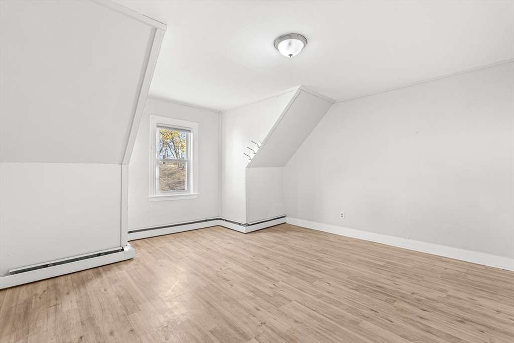 22 Royal Street Boston, MA 02134 - Photo 31 of 42 an empty room with wooden floor and windows