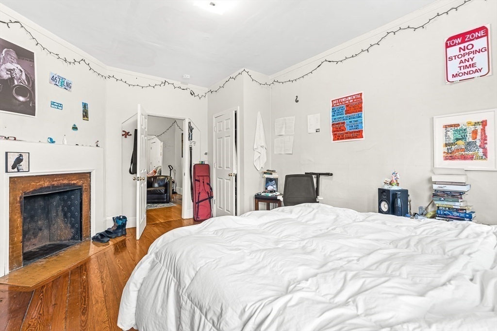 22 Royal Street Boston, MA 02134 - Photo 6 of 42 a bed room with a bed and a fireplace