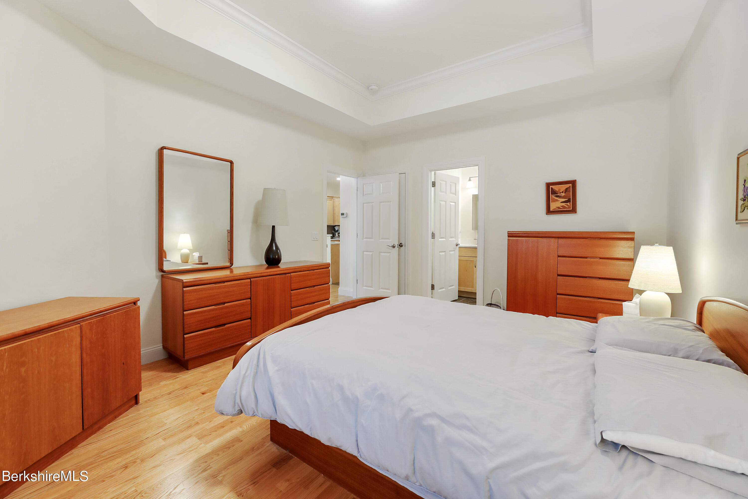 16 Spruce Trail, Unit 16 Lenox, MA 01240 - Photo 13 of 33 a bedroom with a bed and wooden floor