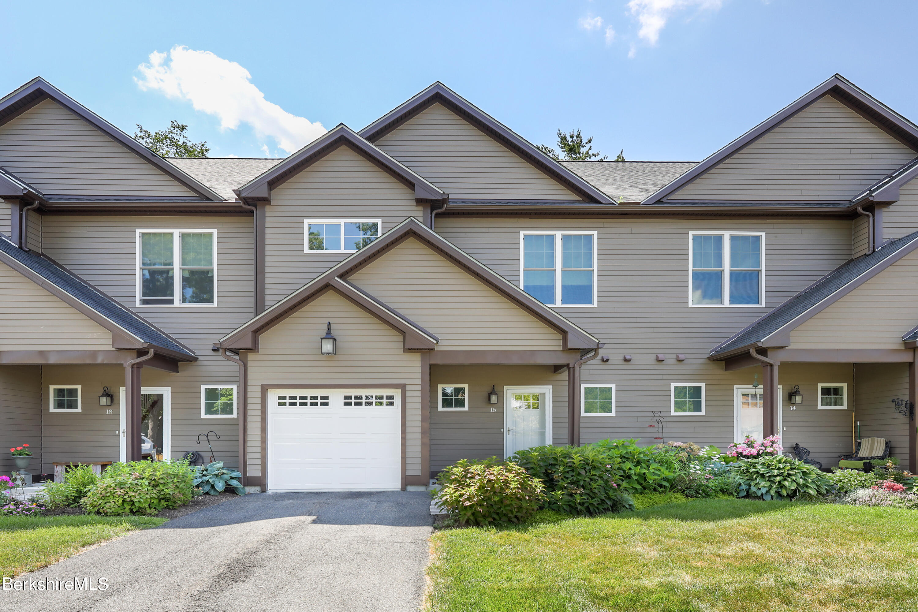 16 Spruce Trail, Unit 16 Lenox, MA 01240 - Photo 2 of 33 a front view of a house with a yard and potted plants