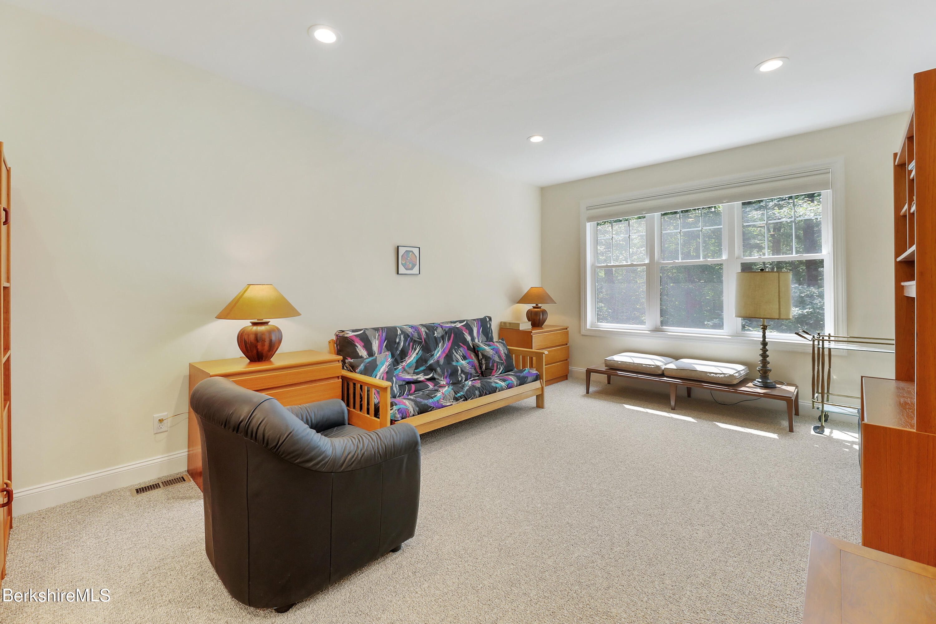 16 Spruce Trail, Unit 16 Lenox, MA 01240 - Photo 23 of 33 a living room with furniture and a flat screen tv