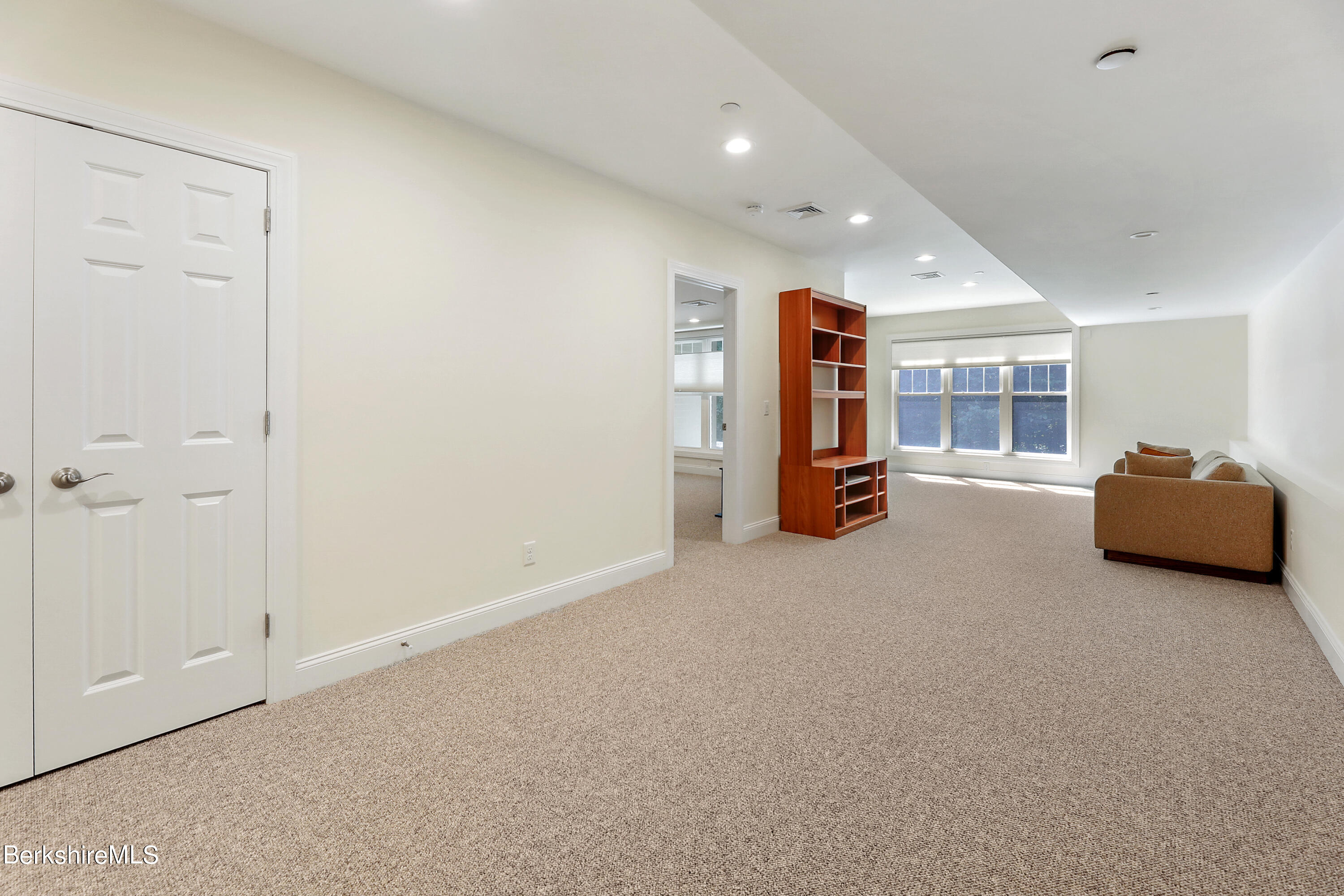 16 Spruce Trail, Unit 16 Lenox, MA 01240 - Photo 27 of 33 a living room with furniture and a walk in closet