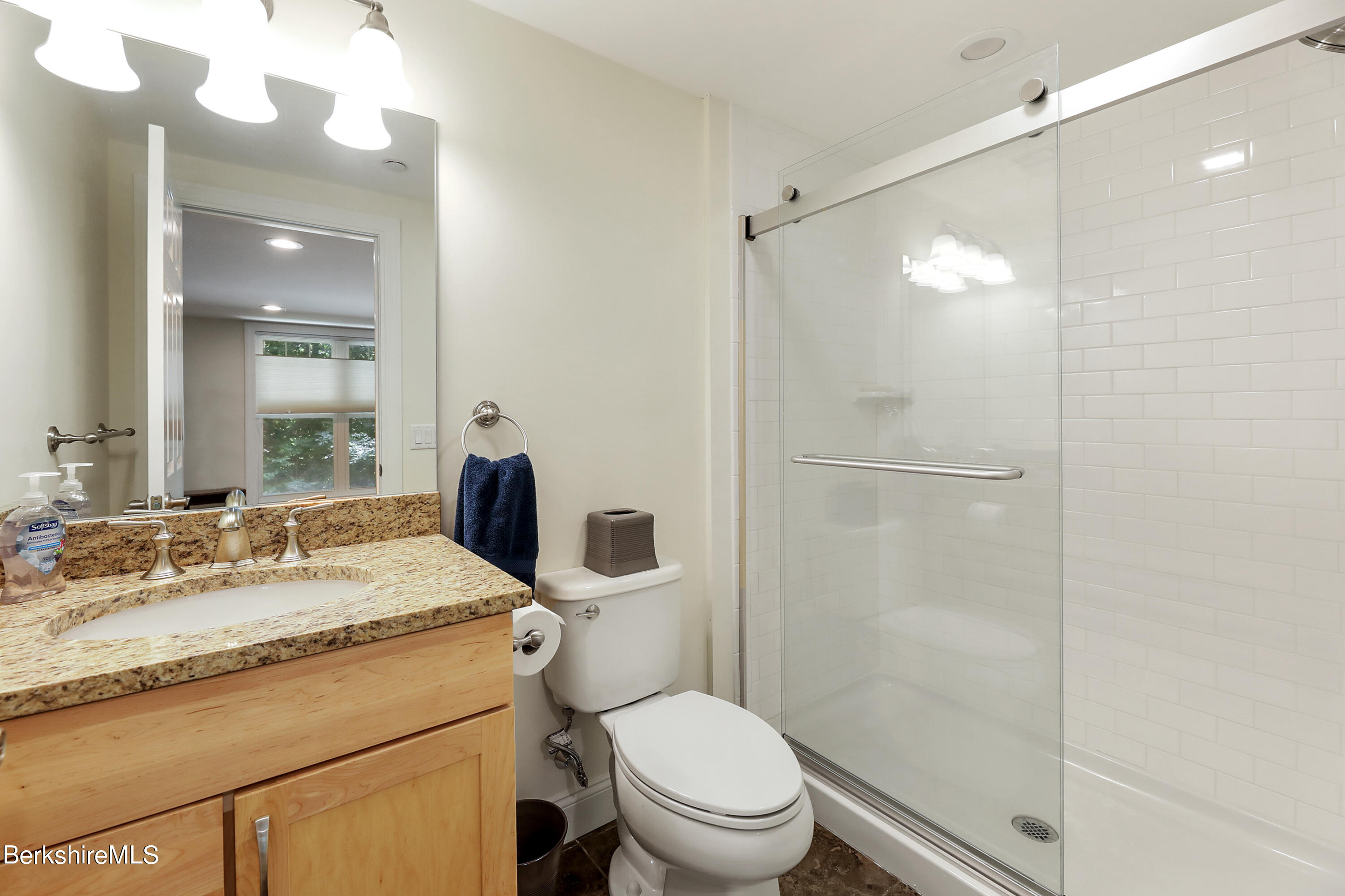 16 Spruce Trail, Unit 16 Lenox, MA 01240 - Photo 30 of 33 a bathroom with a granite countertop sink toilet mirror and shower