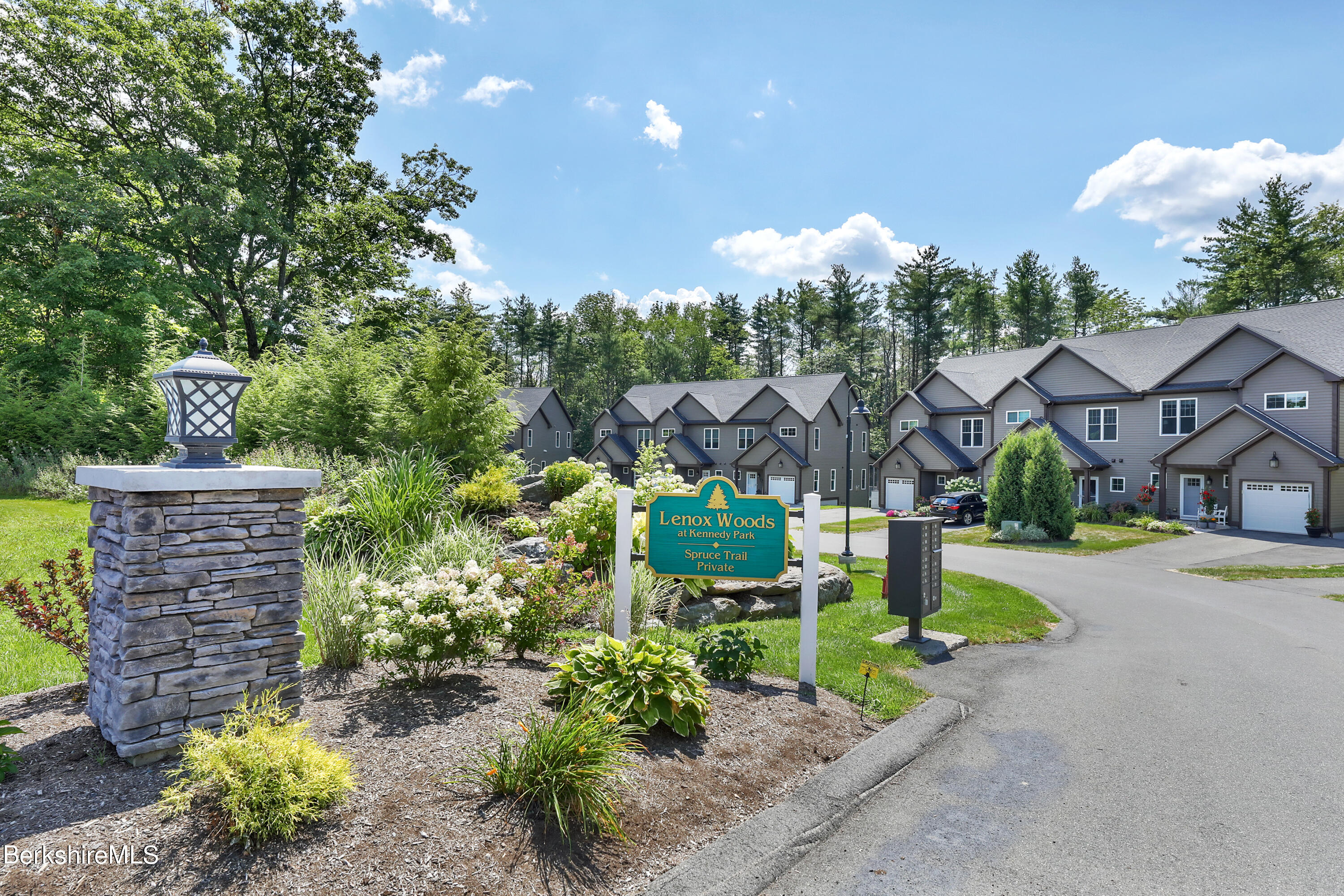 16 Spruce Trail, Unit 16 Lenox, MA 01240 - Photo 3 of 33 a front view of a house with a yard and a garden