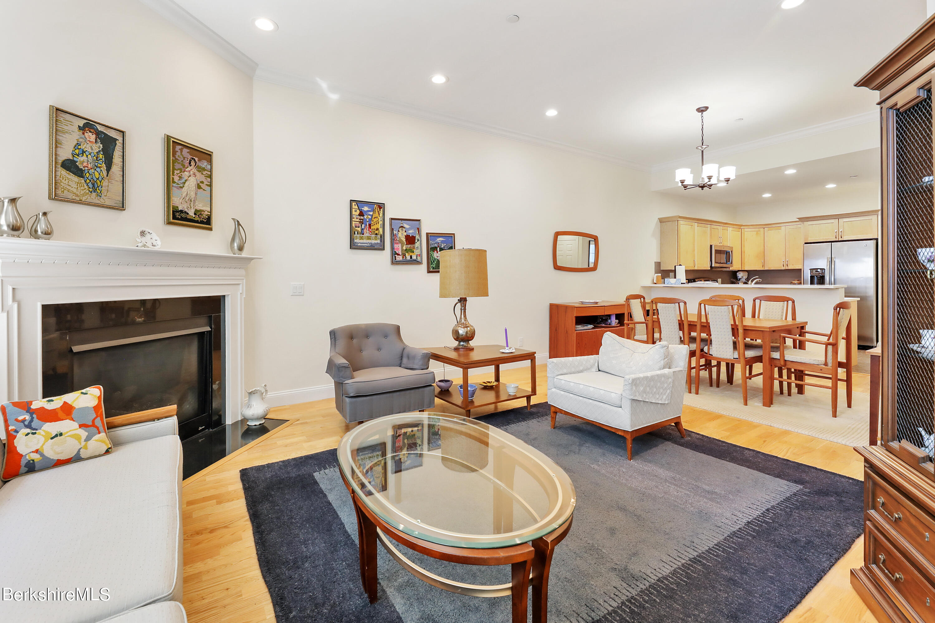 16 Spruce Trail, Unit 16 Lenox, MA 01240 - Photo 4 of 33 a living room with furniture a fireplace and a chandelier