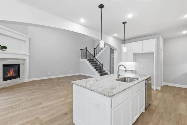 a kitchen with sink cabinets and wooden floor