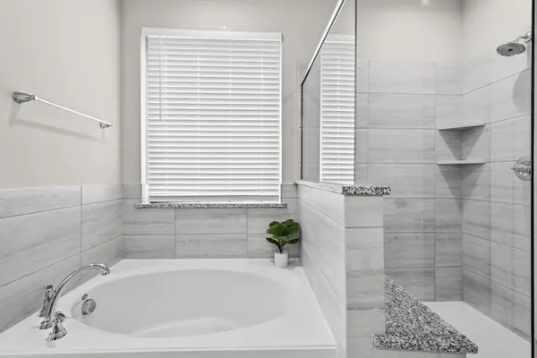 a white bath tub sitting next to a white sink