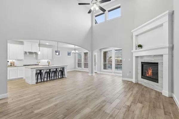 a open kitchen with cabinets and wooden floor