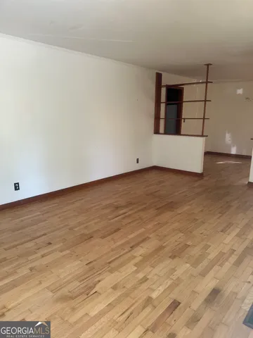 a view of wooden floor and cabinet in a room