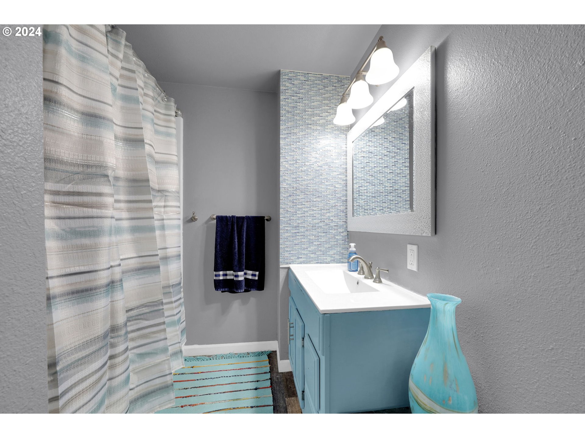 155 South 71st Street Springfield, OR 97478 - Photo 29 of 45 a bathroom with a sink a mirror and a shower