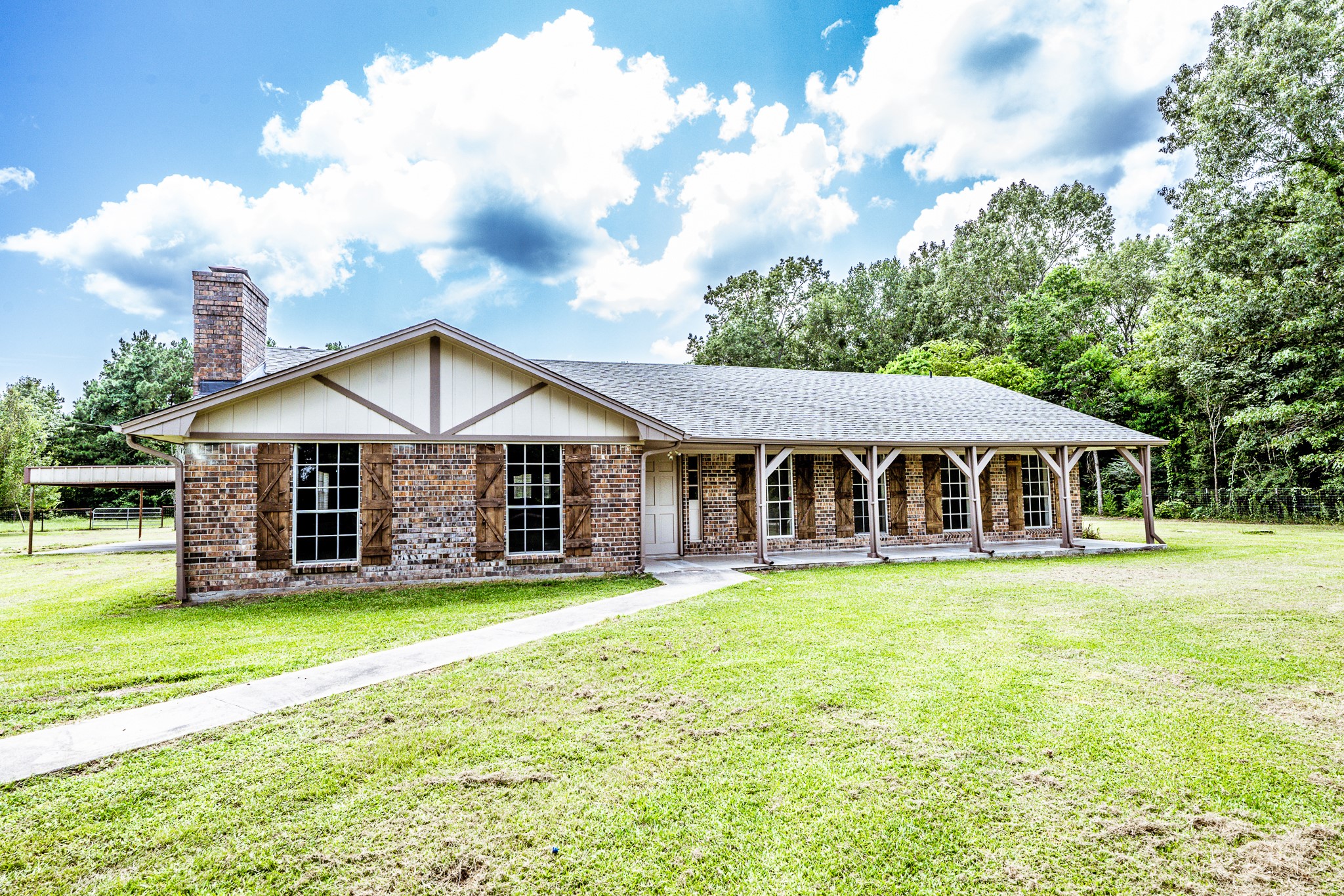 92 A Mt Zion Road New Waverly, TX 77358 - Photo 1 of 29 a view of a house with a big yard and large trees