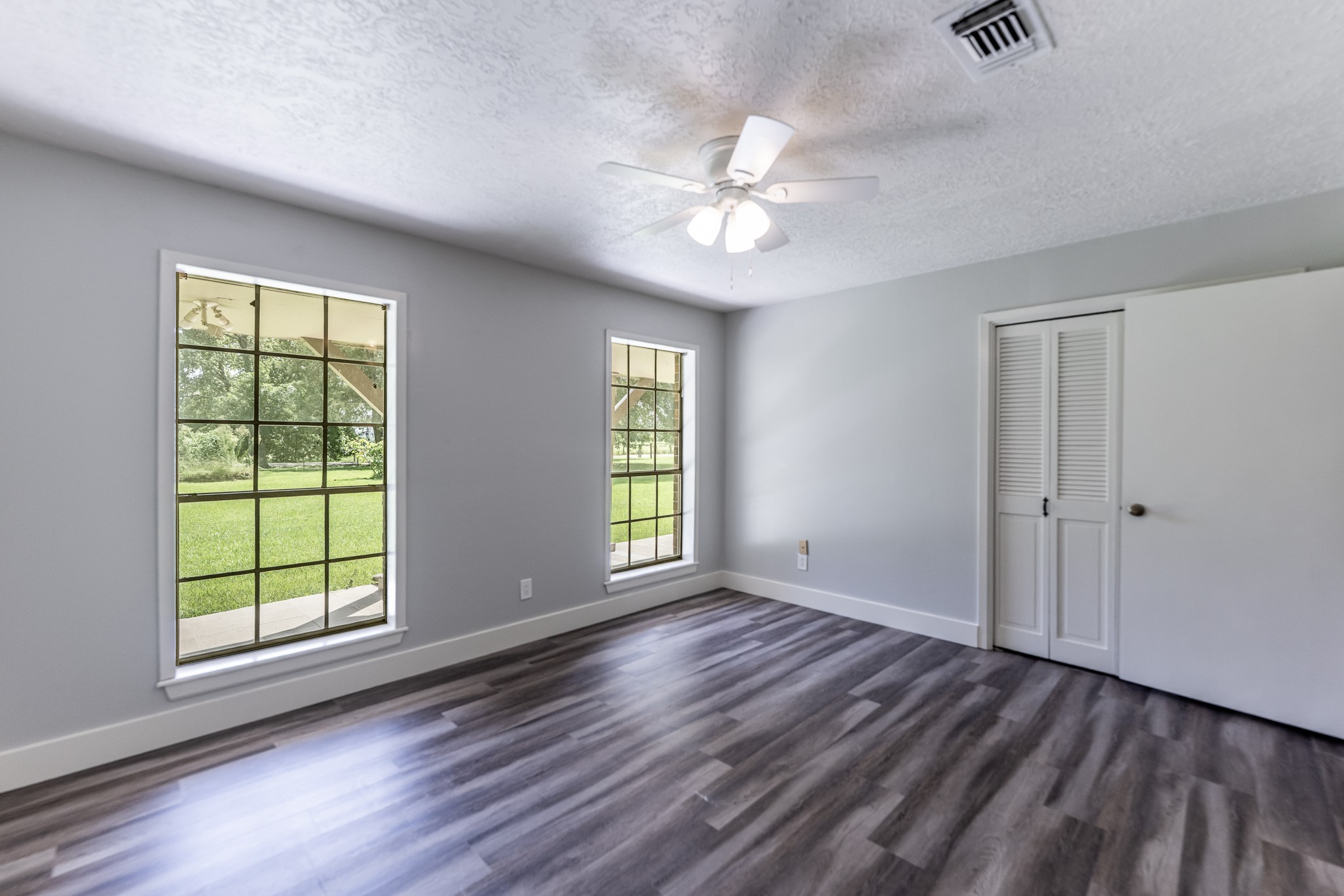 92 A Mt Zion Road New Waverly, TX 77358 - Photo 15 of 29 a view of an empty room with wooden floor and window