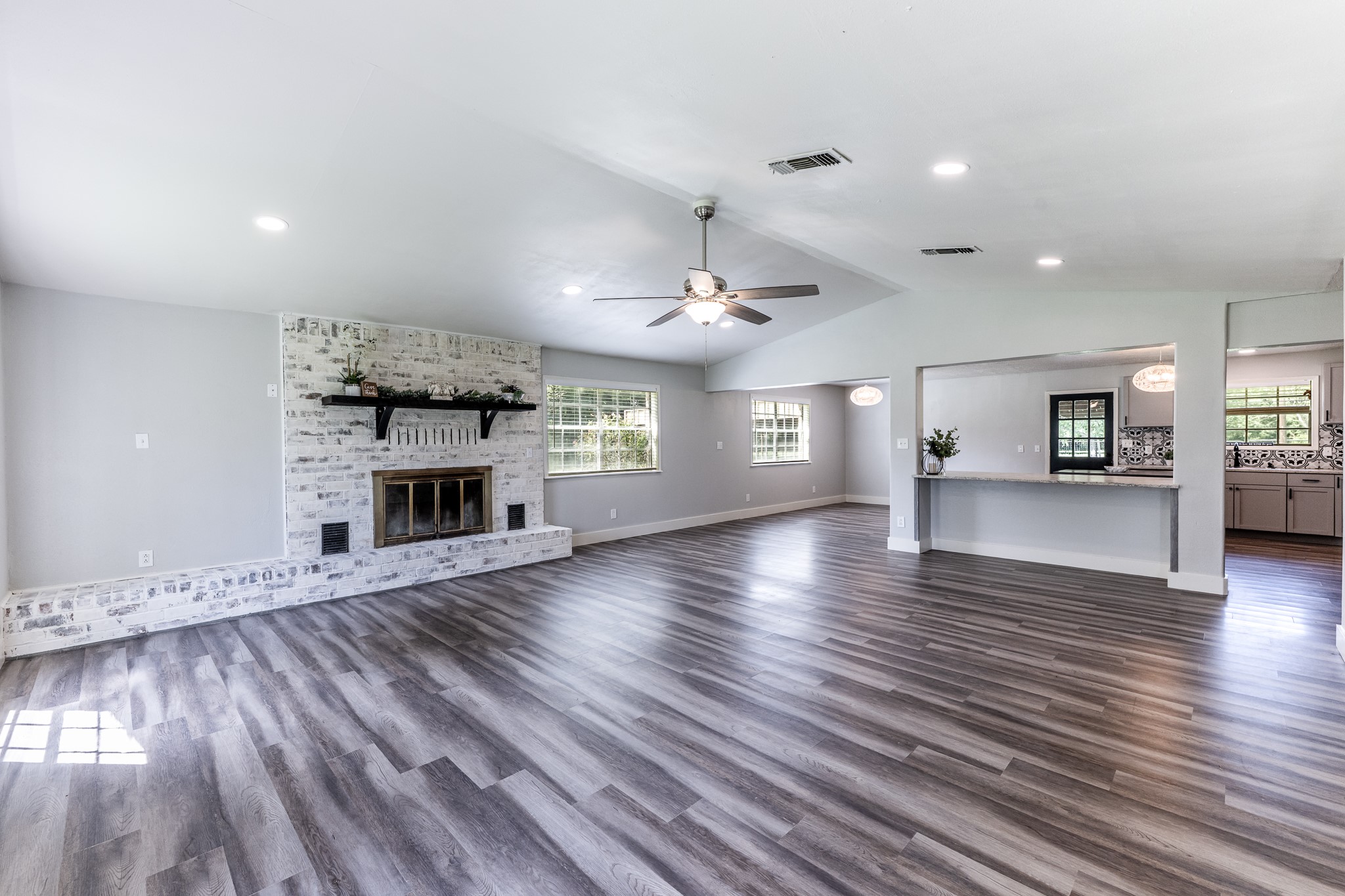 92 A Mt Zion Road New Waverly, TX 77358 - Photo 6 of 29 an empty room with wooden floor fireplace and windows