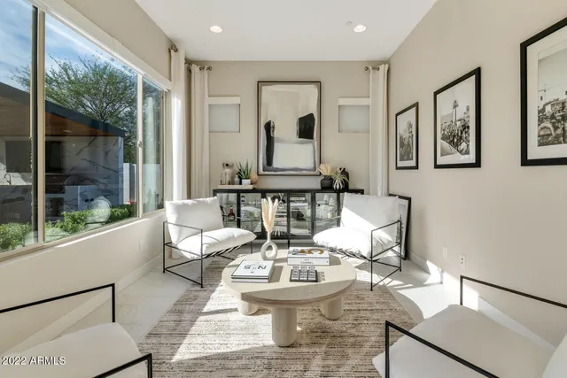 a living room with fireplace furniture and a large window